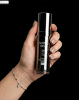 Hand holding HOP PLLA CAVIPLLA O2 skincare bottle with 'SKIN ACCORD' branding against a black background