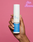 Hand holding a KRX Probiotic Toner skincare product with a pink background and 'Skin Accord' branding.