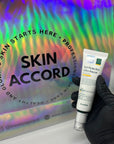 Picture of esthetician hand holding Dr. Esthe Sun Protection Ultra Repair Sunscreen at Skin Accord New Lenox, IL