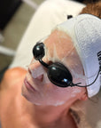 Person receiving a facial treatment with HOP PLLA mask and goggles at Skin Accord.