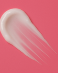 White cream swatch on a pink background