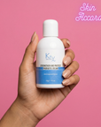 Hand holding a bottle of KRX Probiotic Cream against a pink background with 'Skin Accord' branding.