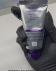 A black gloved hand holding HOP Volume Boost Moisturizer at Skin Accord in New Lenox, IL