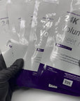 Picture of esthetician black gloved hand holding House of PLLA HOP 24k Gold Volumizing Sheet Mask at Skin Accord in New Lenox, IL