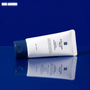 Tube of AC FIT Sang Cream on a reflective blue surface with a blue backgrounD