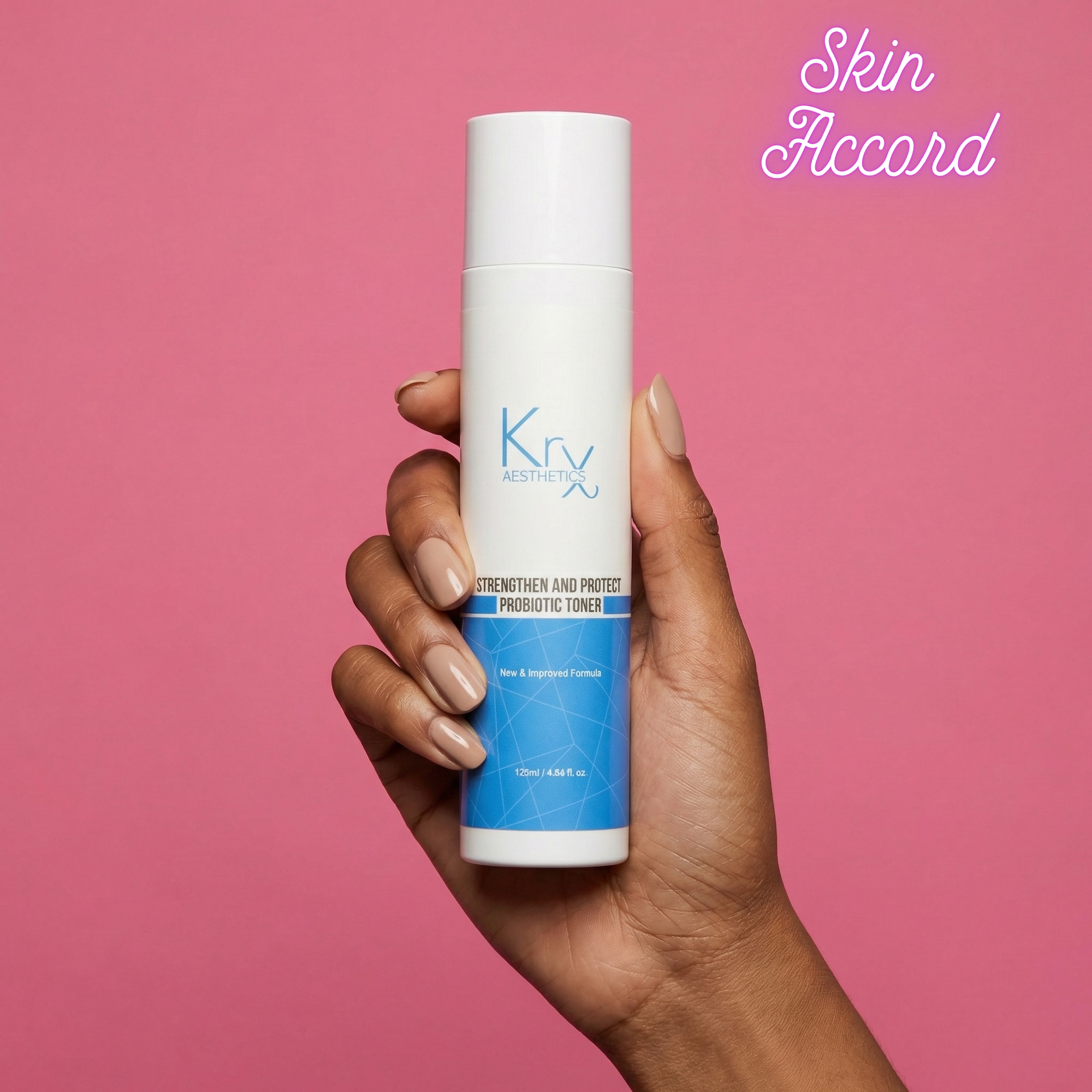 Hand holding a KRX Probiotic Toner against pink background and 'Skin Accord' branding.