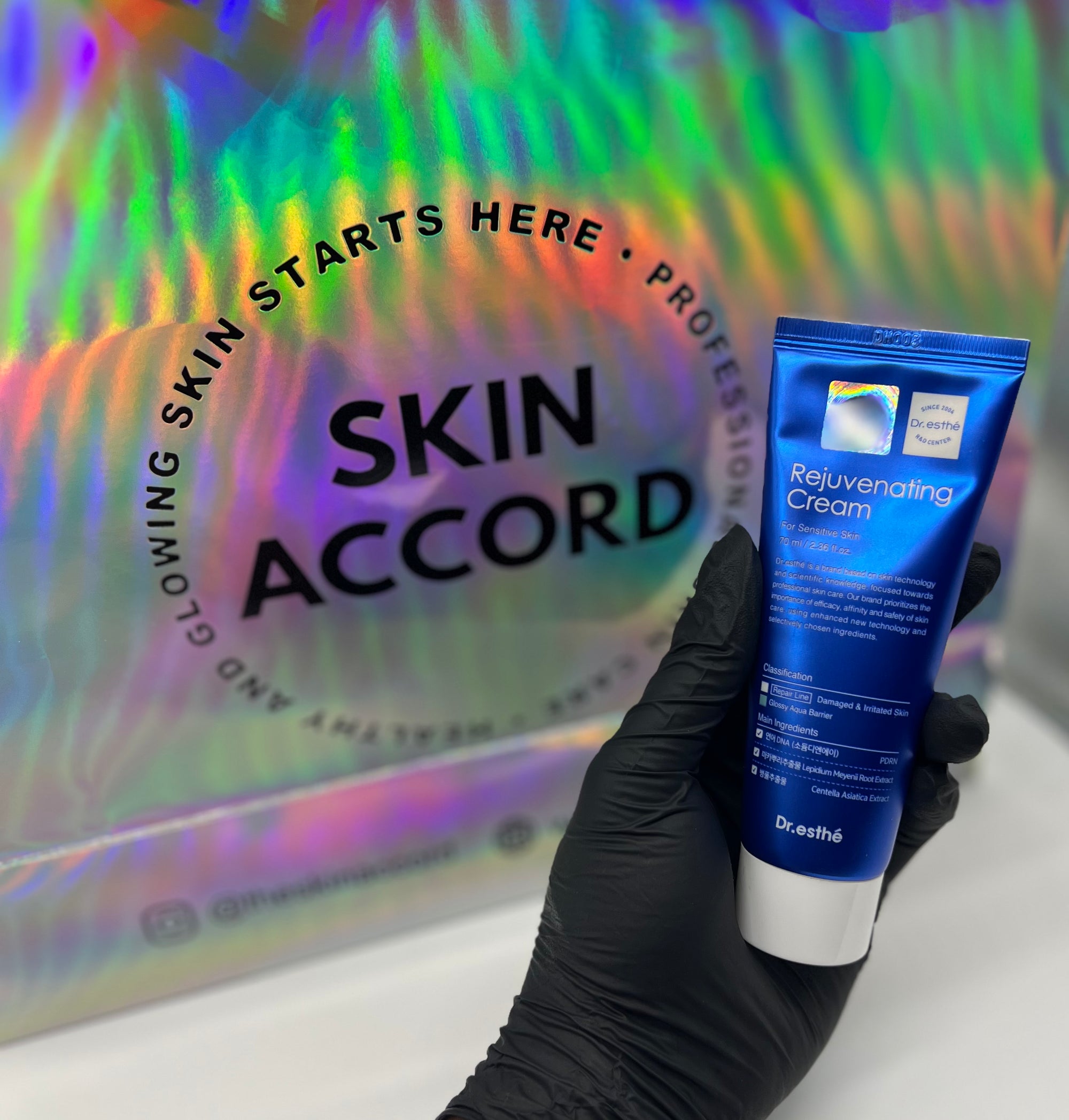 Picture of esthetician hand holding Dr.Esthe Rejuvenating Cream at Skin Accord