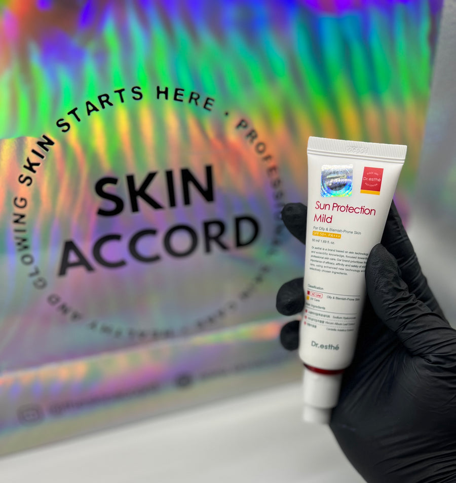 Picture of esthetician hand holding Dr.Esthe Sun Protection Mild Sunscreen at Skin Accord New Lenox, IL 