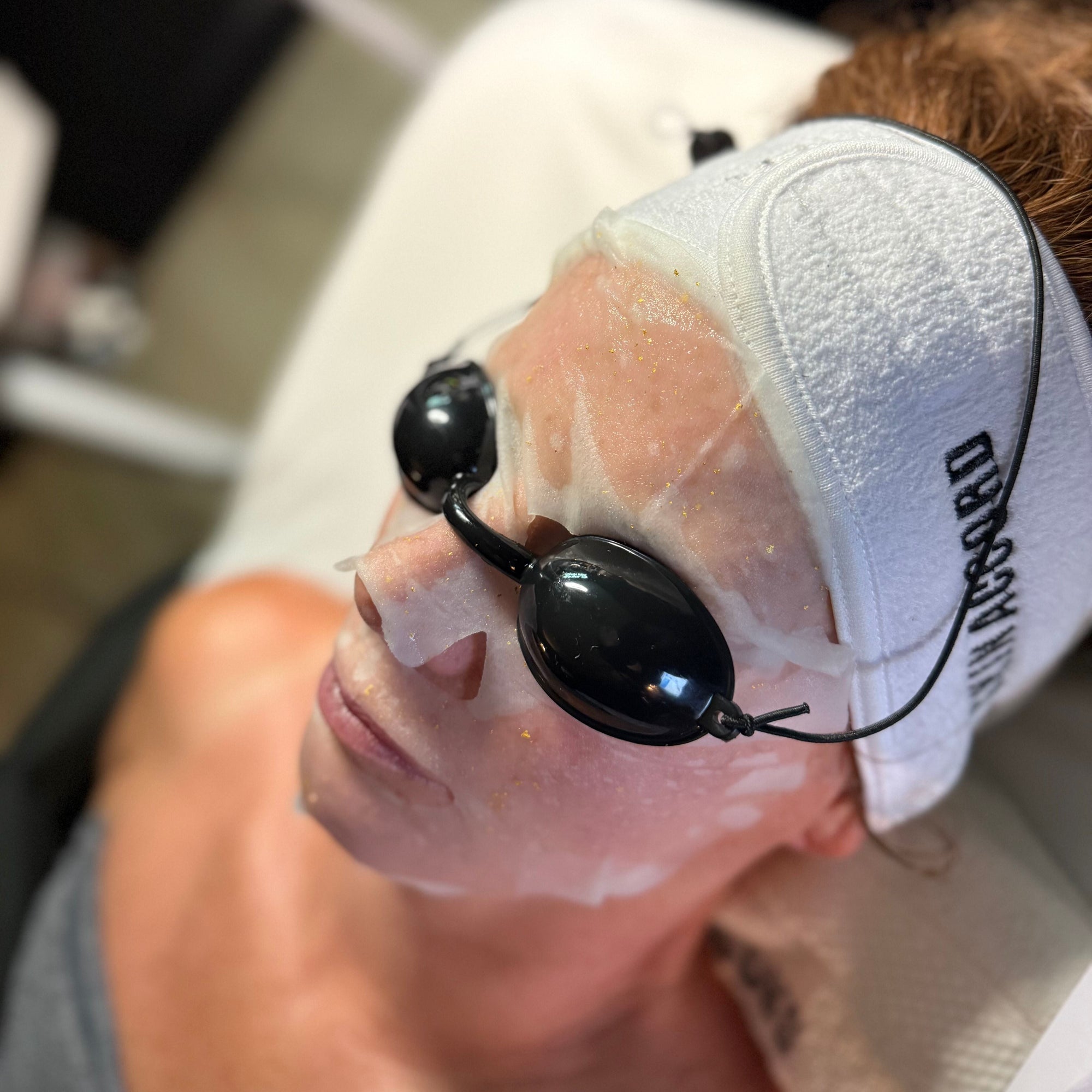 Person receiving a facial treatment with HOP PLLA mask and goggles at Skin Accord. 