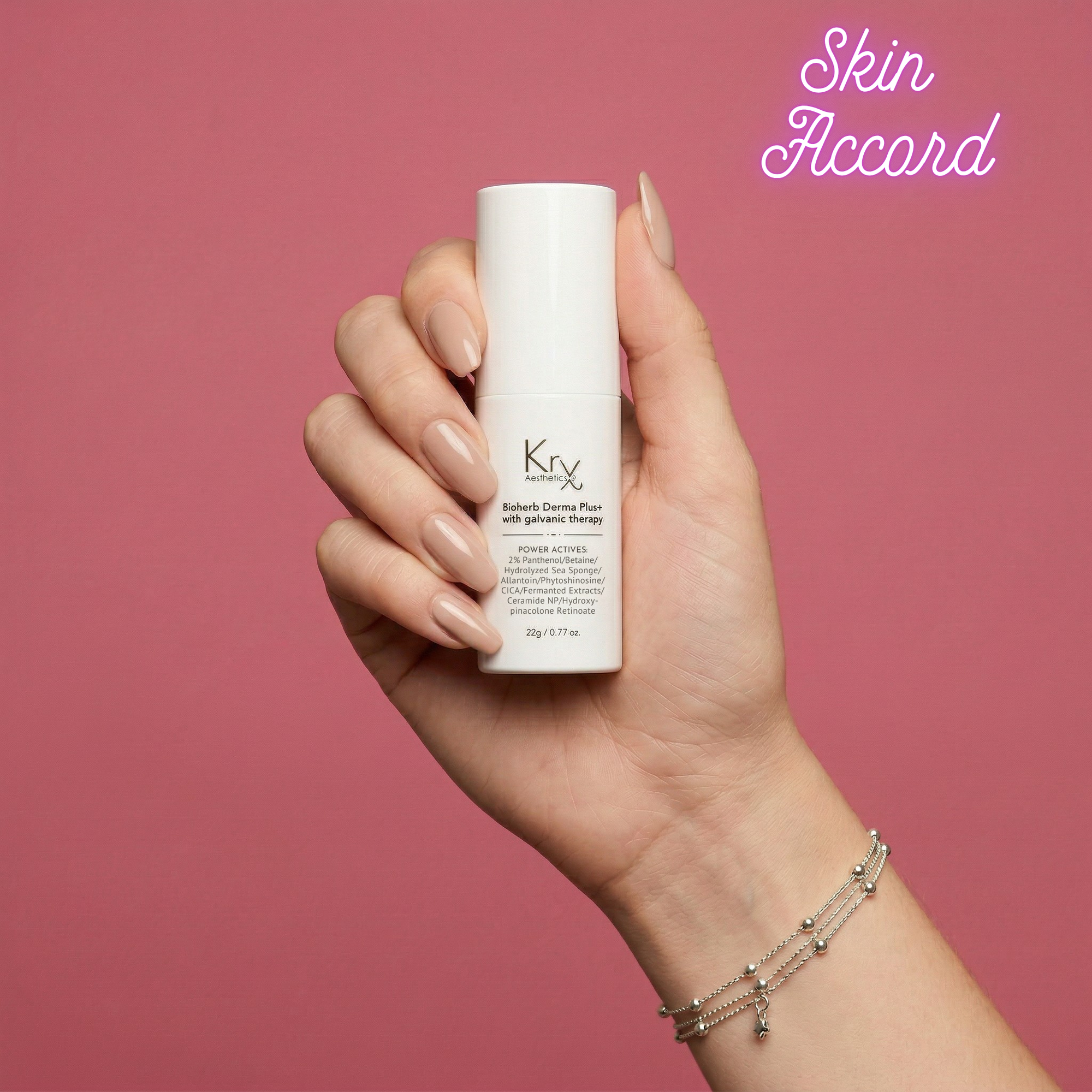 Hand holding KRX Bioherb Cream Plus Galvanic Therapy with 'Skin Accord' branding on a pink background