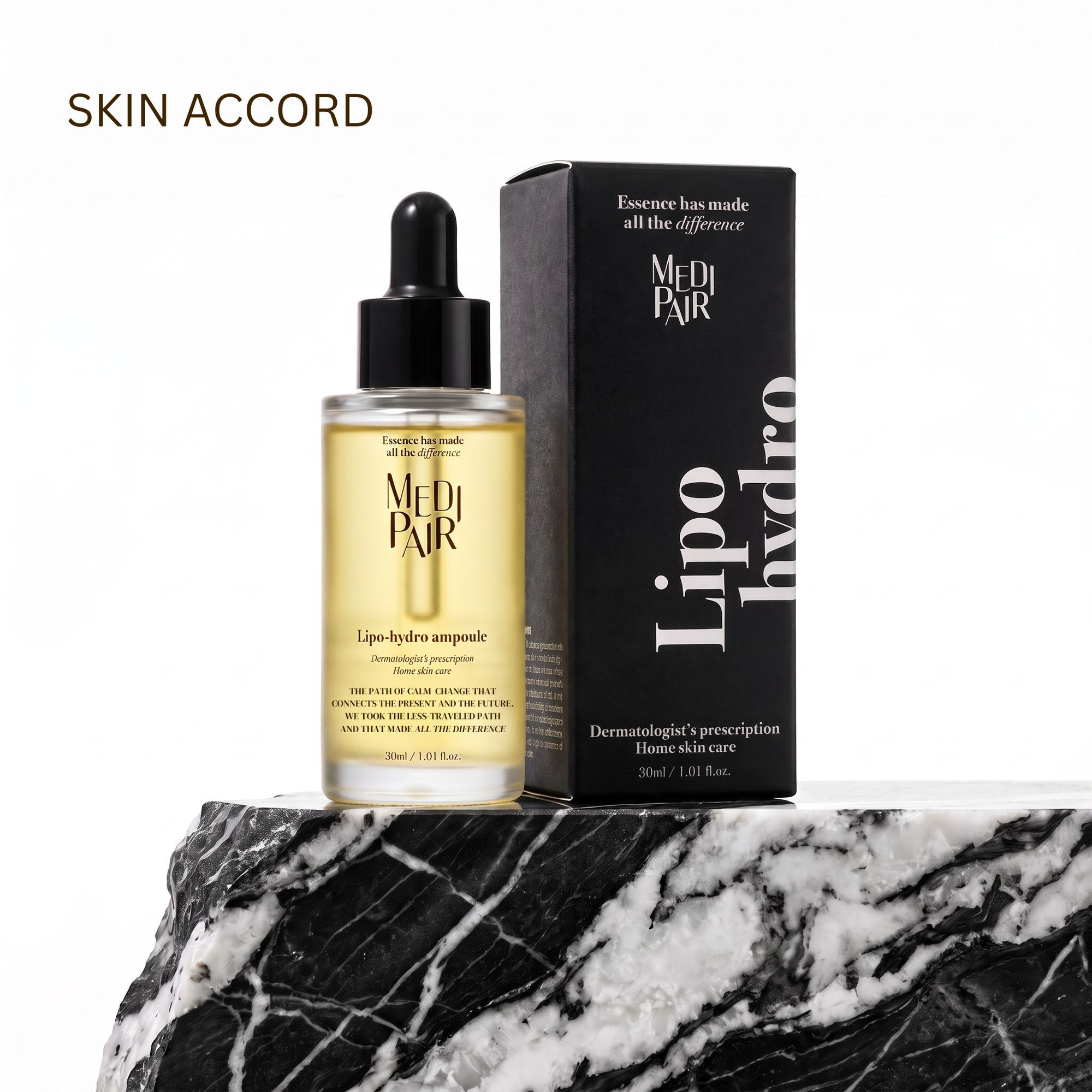 Medi Pair Lipo Hydro serum in a clear dropper bottle with golden-yellow liquid, displayed next to its black packaging box on a black and white marble surface against a white background.