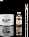 HEVATOX skincare products including a jar, bottle, and pen on a reflective surface with a black background.