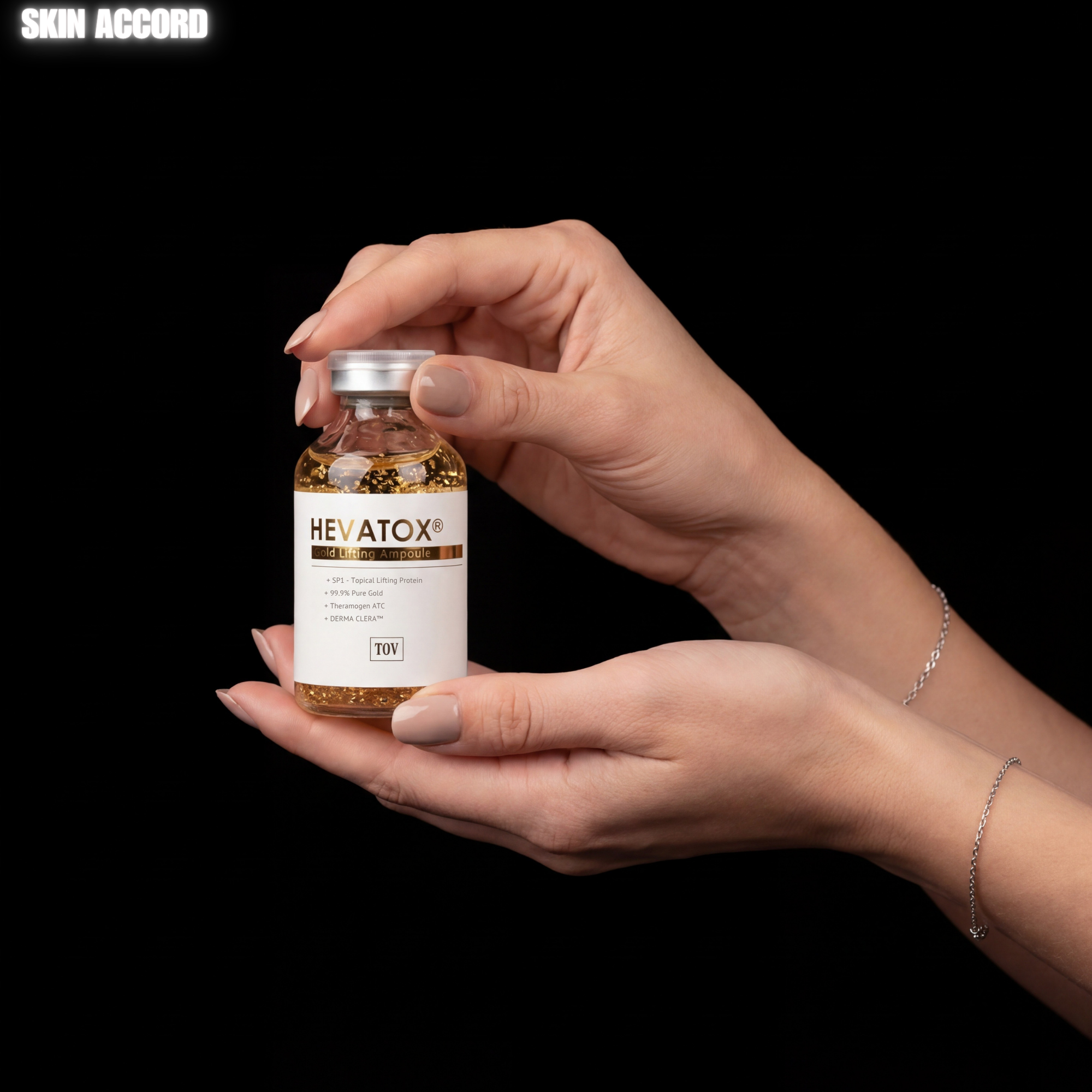Hand holding a Hevatox Gold Ampoule skincare product against a black background