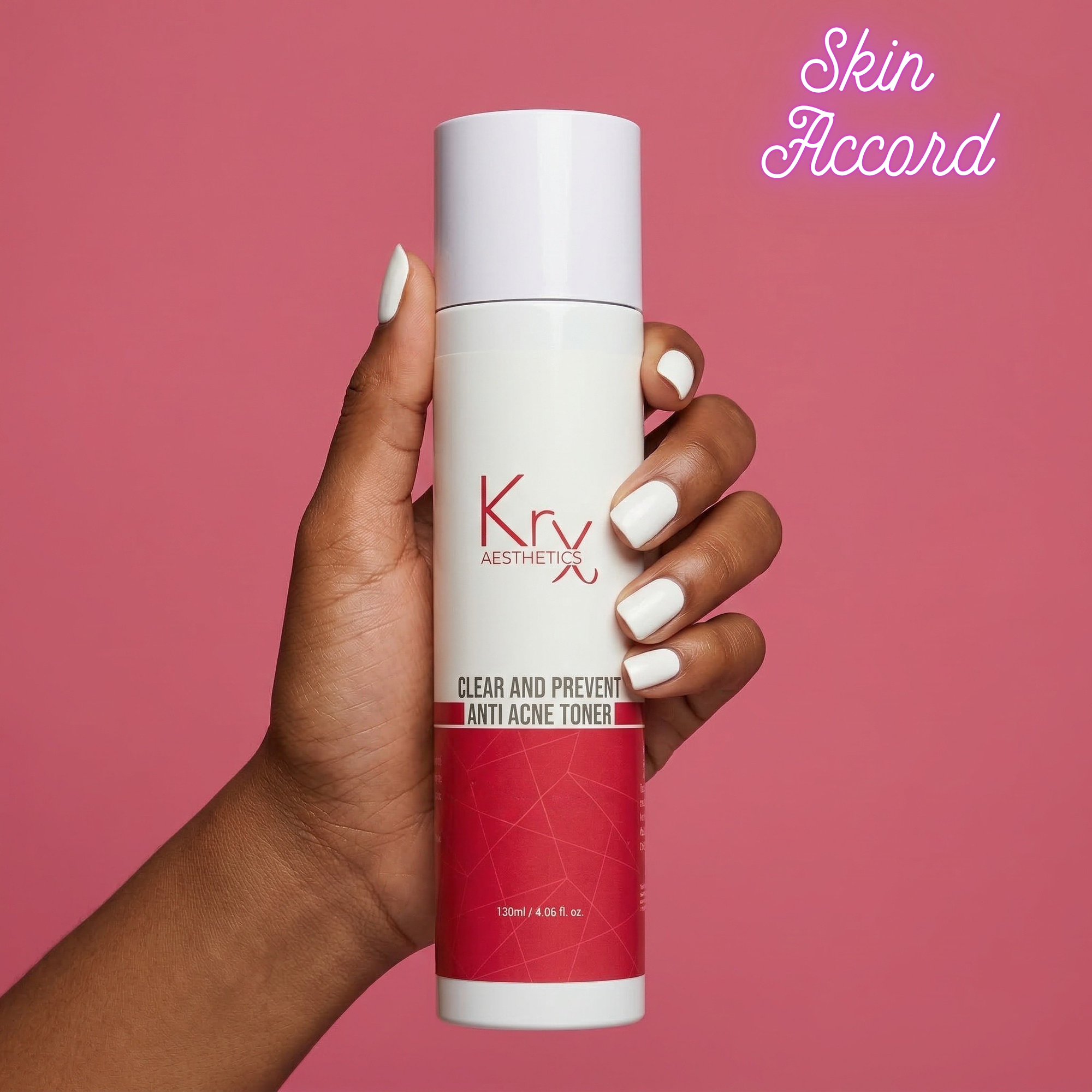 Hand holding a Krx Aesthetics anti-acne toner bottle against a pink background