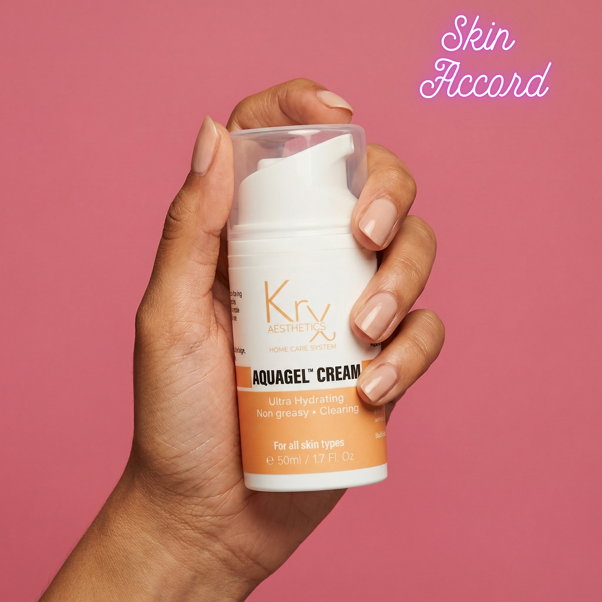 Hand holding a container of Krx Aquagel Cream with a pink background