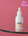 KRX All Day Glow Vitamin Serum bottle on a glass table with a pink background
