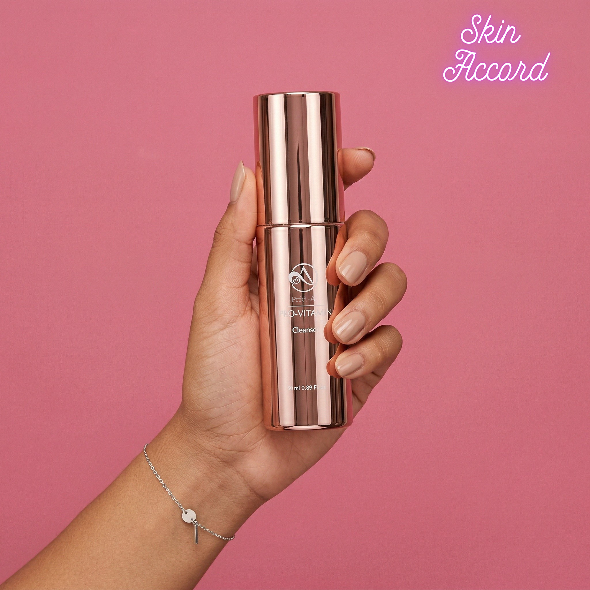 Hand holding PFECT-A Pro Vitamin Low PH skincare bottle against a pink background